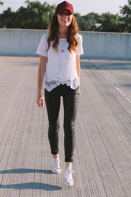 a girl in white shirt wearing a baseball cap