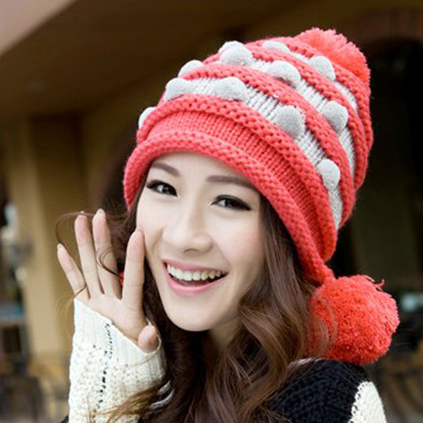 a girl wearing a beanie hat in red and white